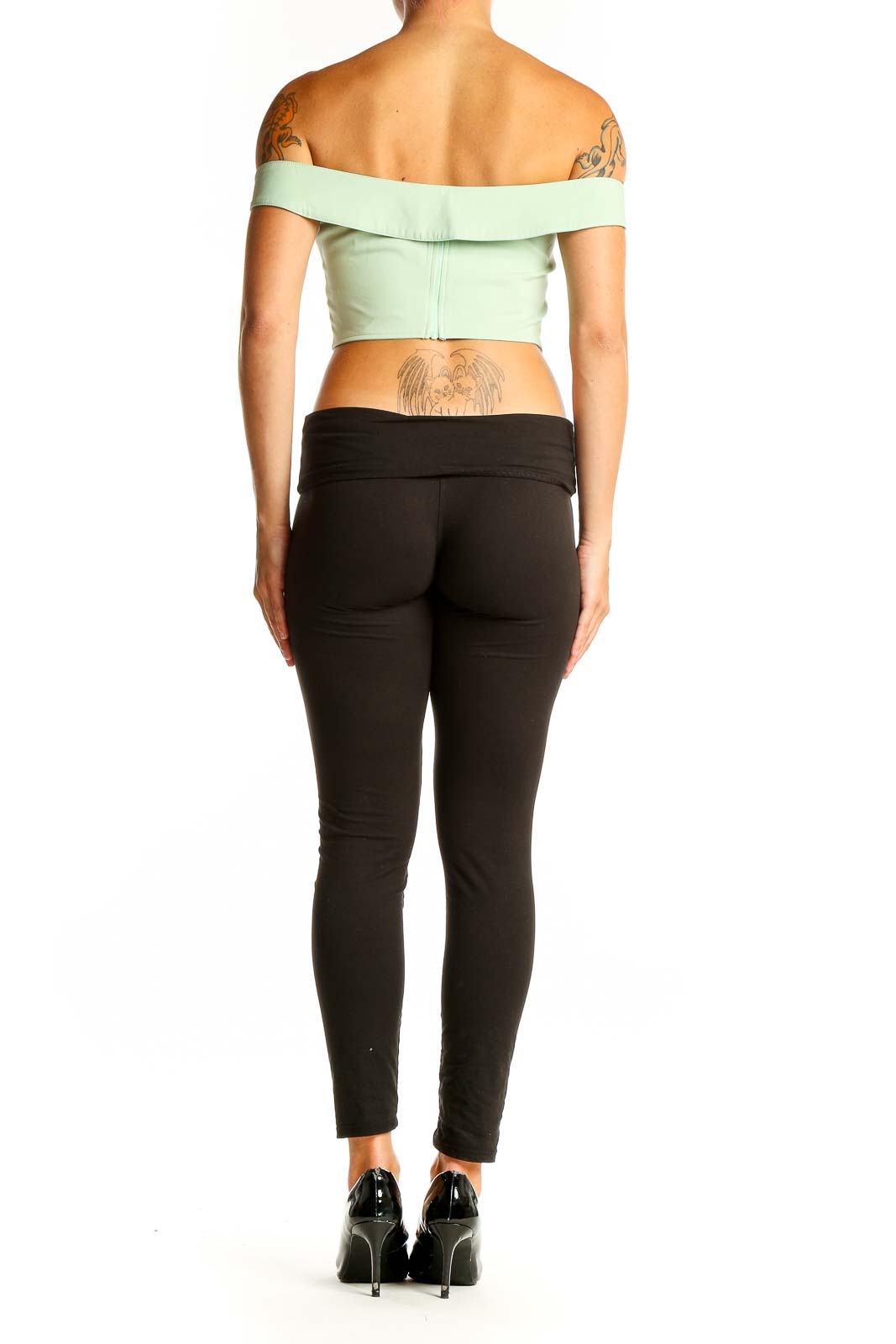 Side view of Cider mint green off-shoulder crop top on model with black pants