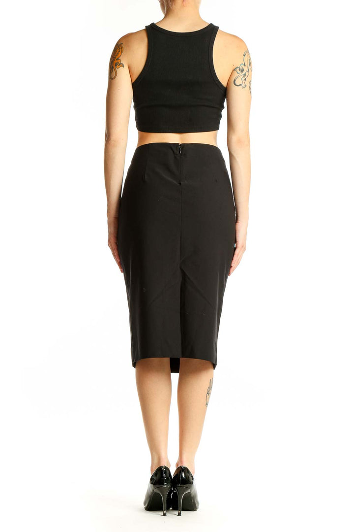 Side view of model wearing Donna Karan New York black pencil skirt with crop top