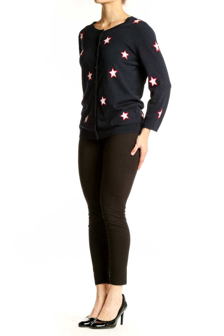 Front view of Talbots black cardigan with white and red star pattern