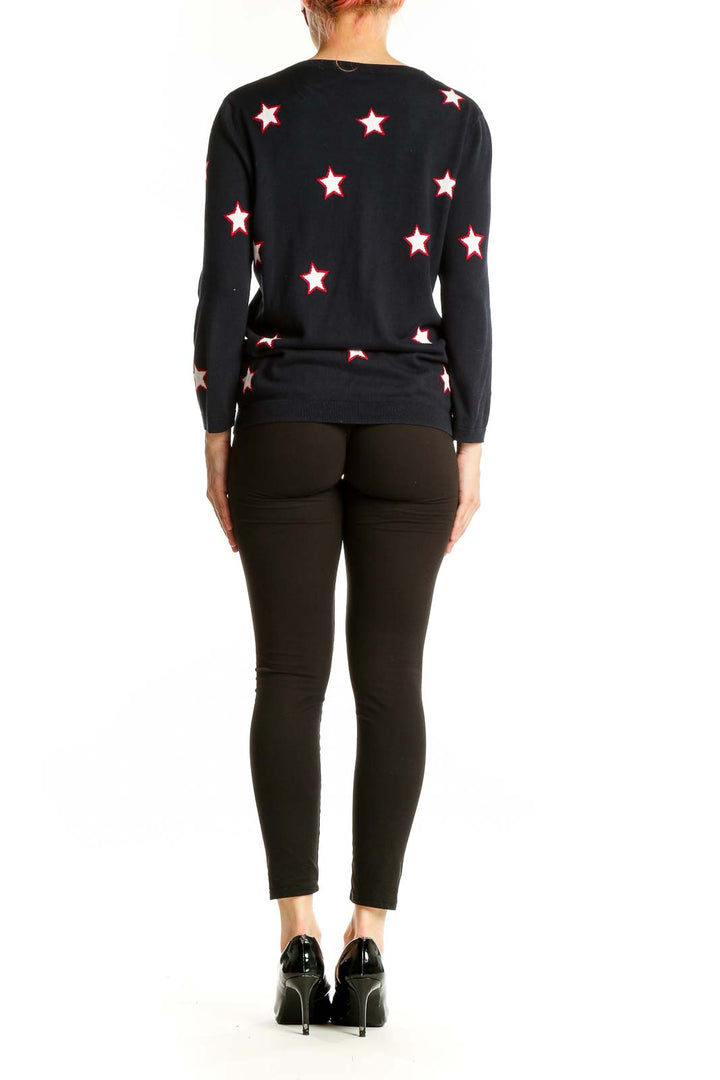 Side view of woman wearing Talbots black star-patterned cardigan with black pants