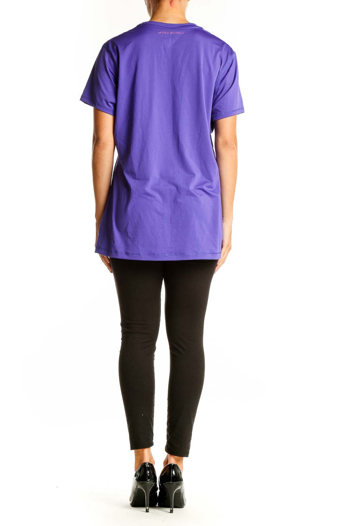 Side view of woman wearing purple Under Armour performance t-shirt