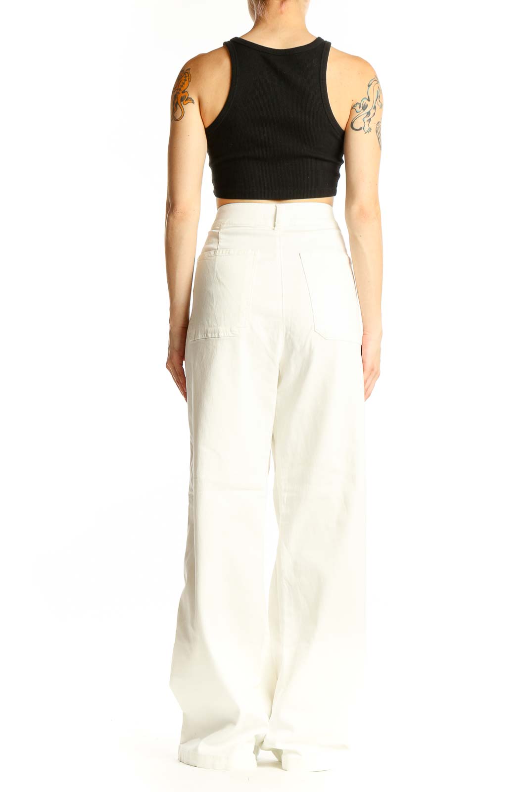 Side view of model wearing white high-waisted wide-leg denim pants
