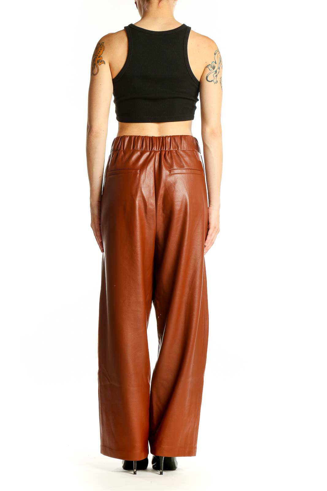 Side view of model wearing BLANKNYC brown faux leather wide-leg pants