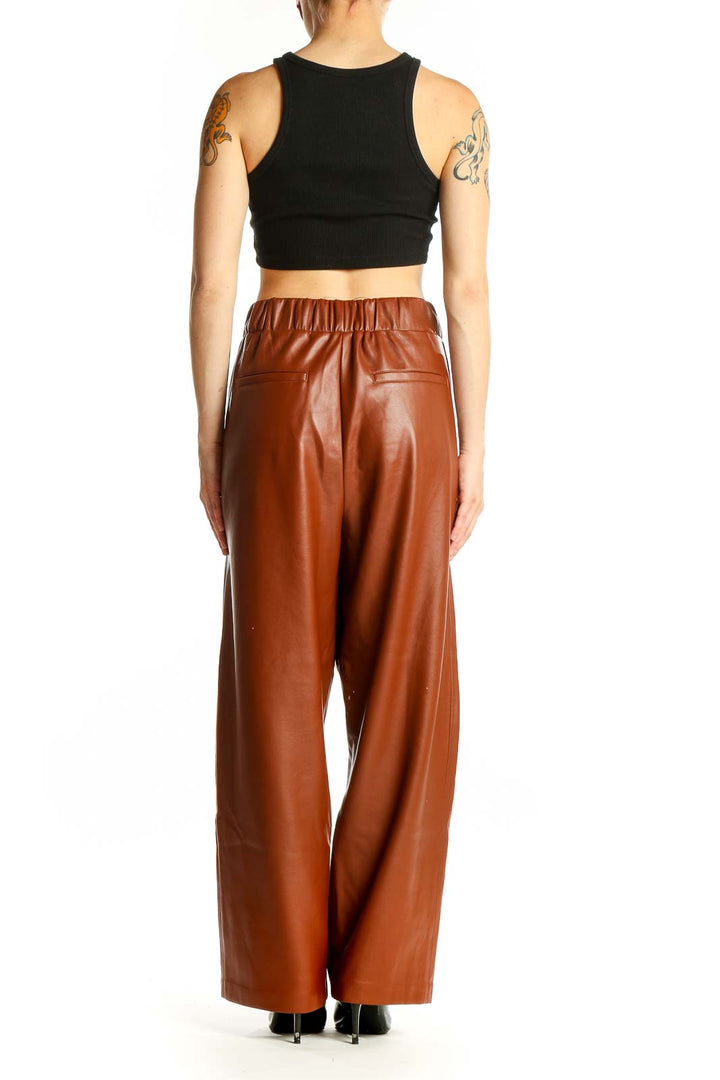 Side view of model wearing BLANKNYC brown faux leather wide-leg pants