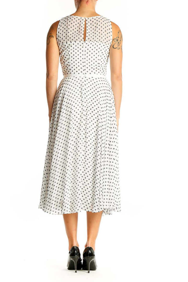 Side view of Hobbs London white sleeveless midi dress with black polka dots