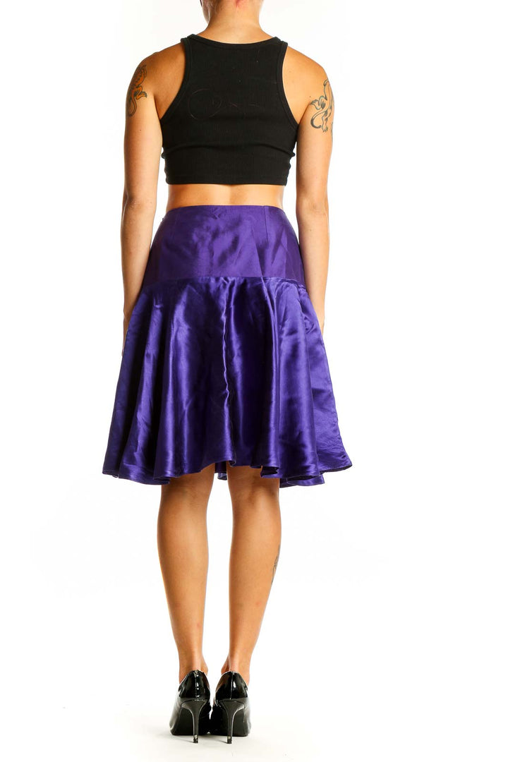 Side view of model wearing purple satin A-line knee-length skirt by KITH & KIN