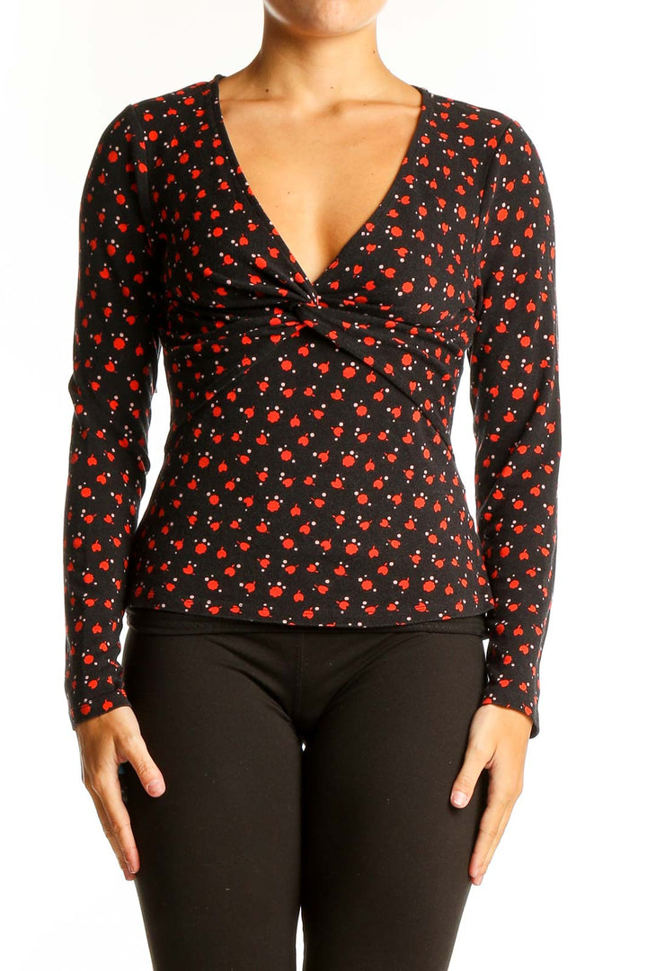 Front view of Boden black V-neck top with red cherry blossom print and twist detail