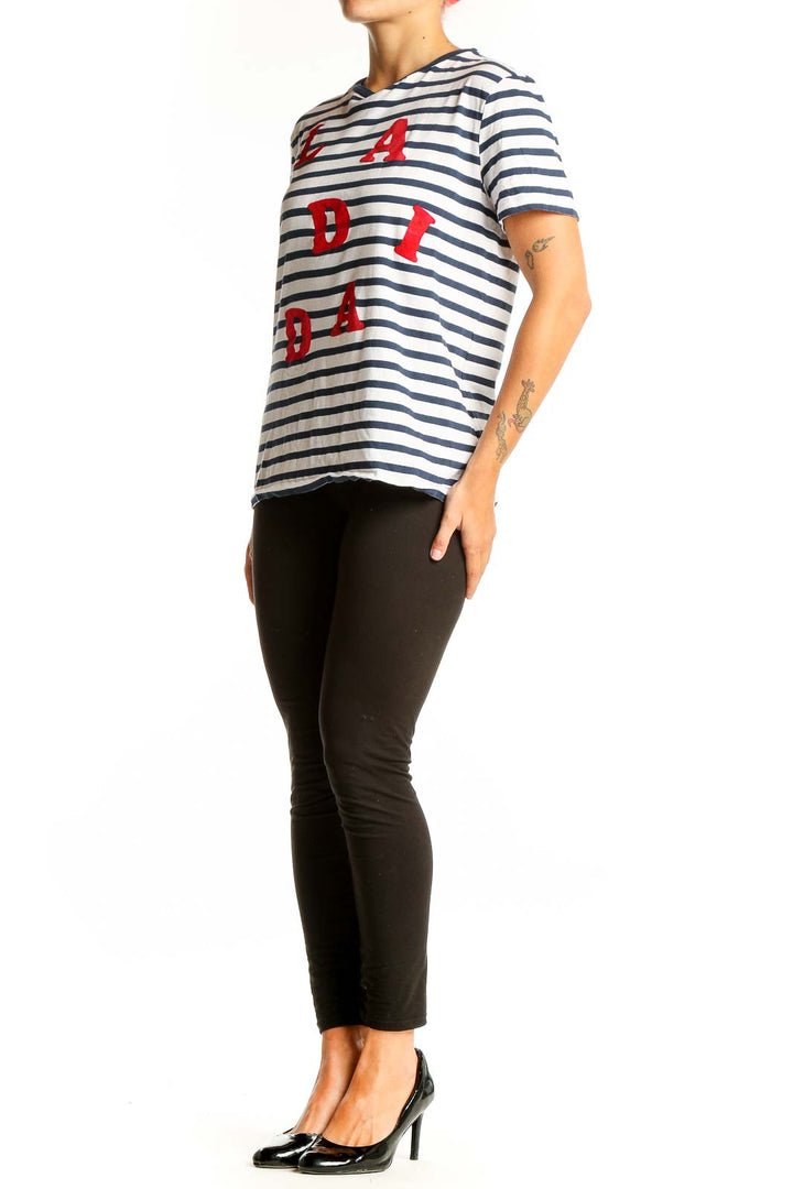 Front view of Etre cecile navy and white striped t-shirt with red LA DADA lettering