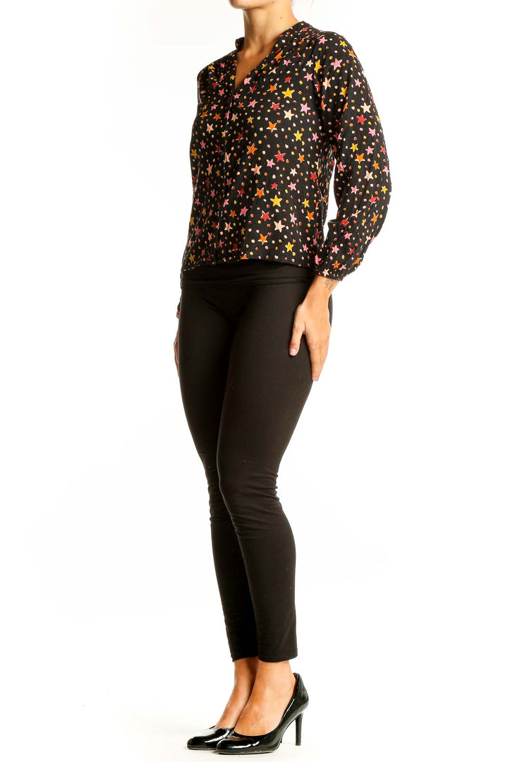 Front view of Sugarhill Brighton black blouse with colorful star print