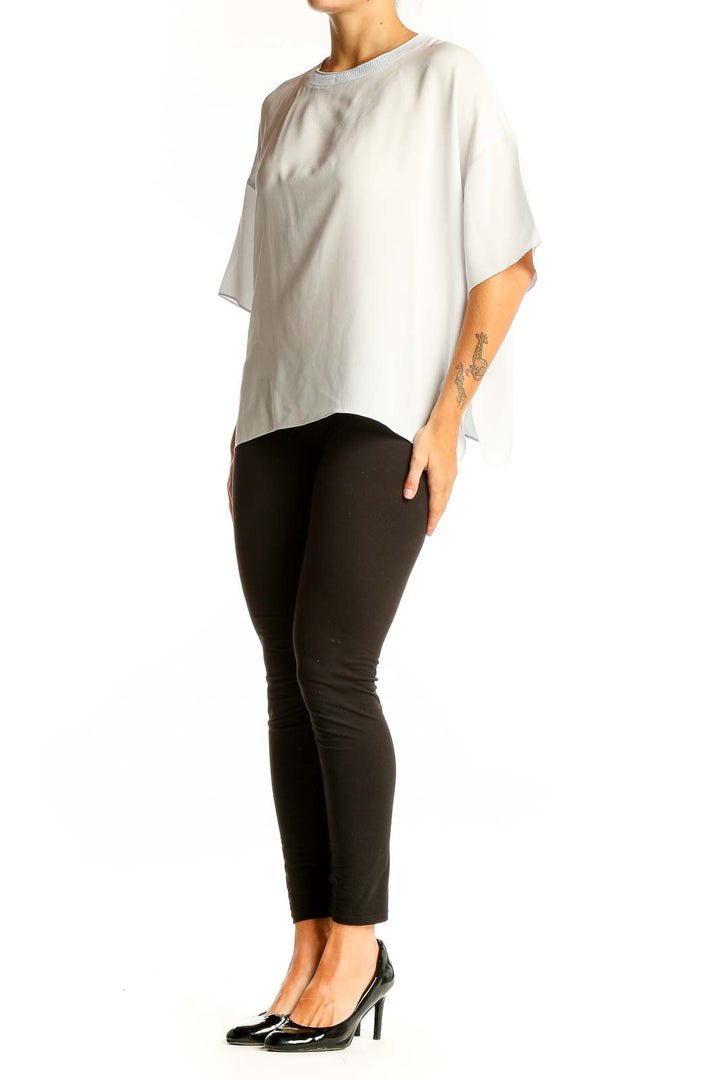 Front view of white silk oversized blouse by Vince