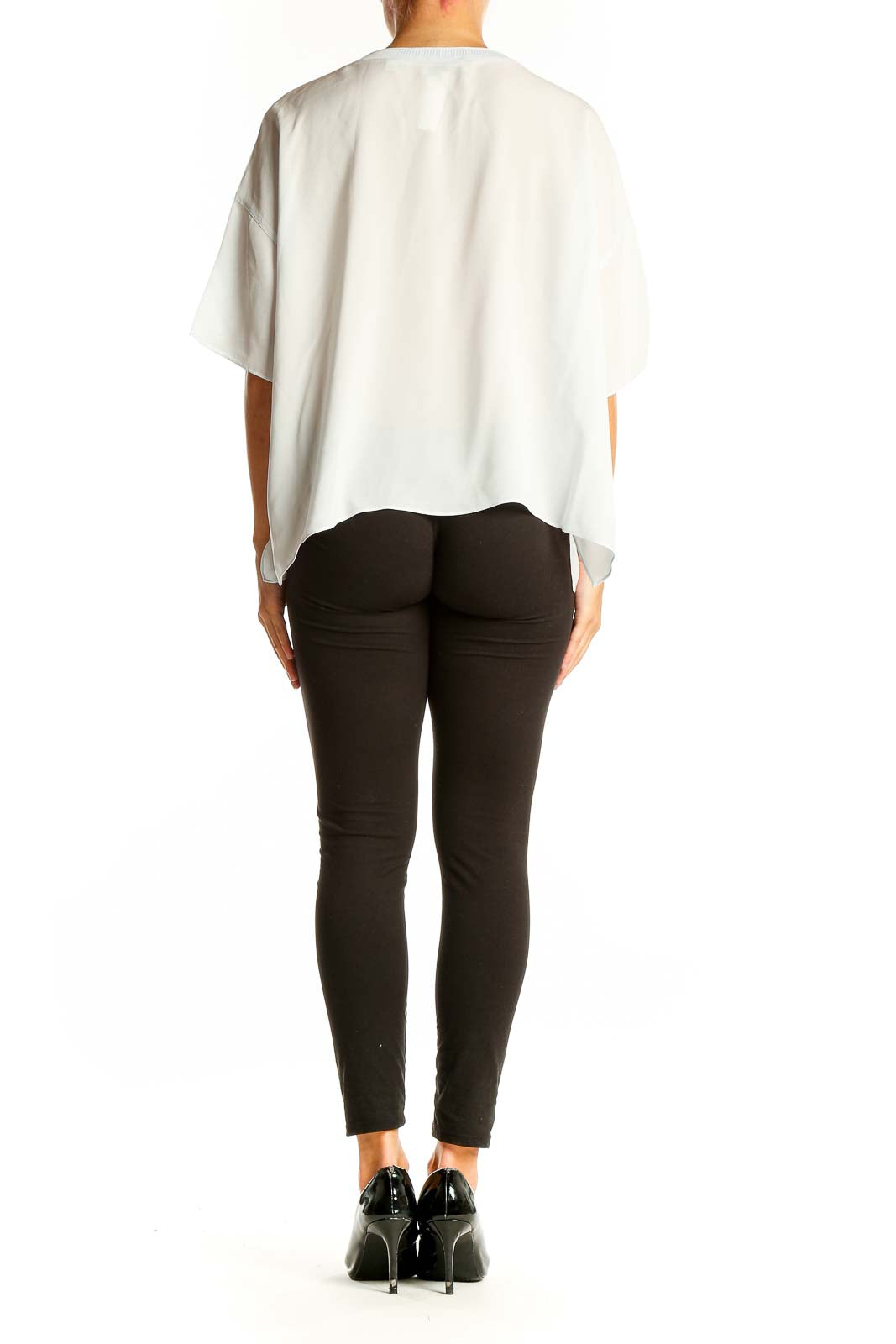 Back view of white silk oversized blouse by Vince on model