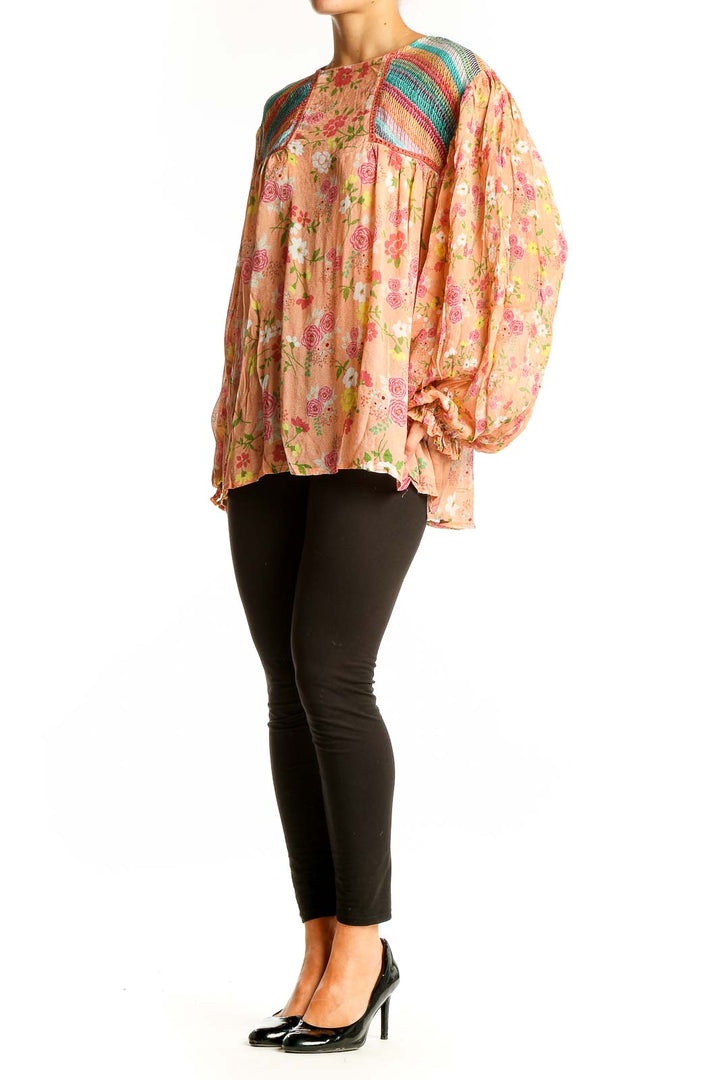 Front view of peach floral blouse with rainbow crochet shoulders