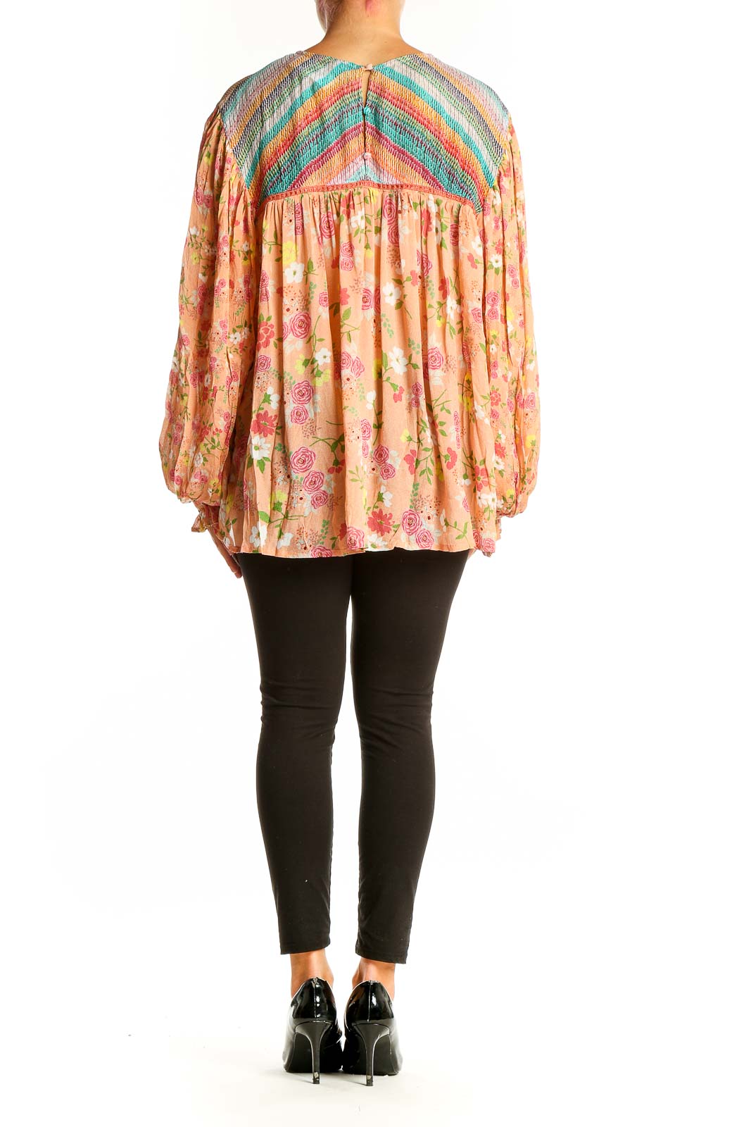 Side view of peach floral blouse showing bishop sleeves and relaxed fit