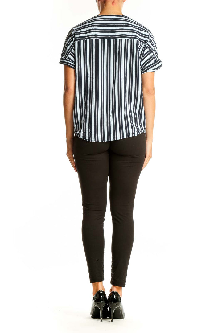 Side view of Ellen Tracy Black and White Striped Wrap Top on model with black pants