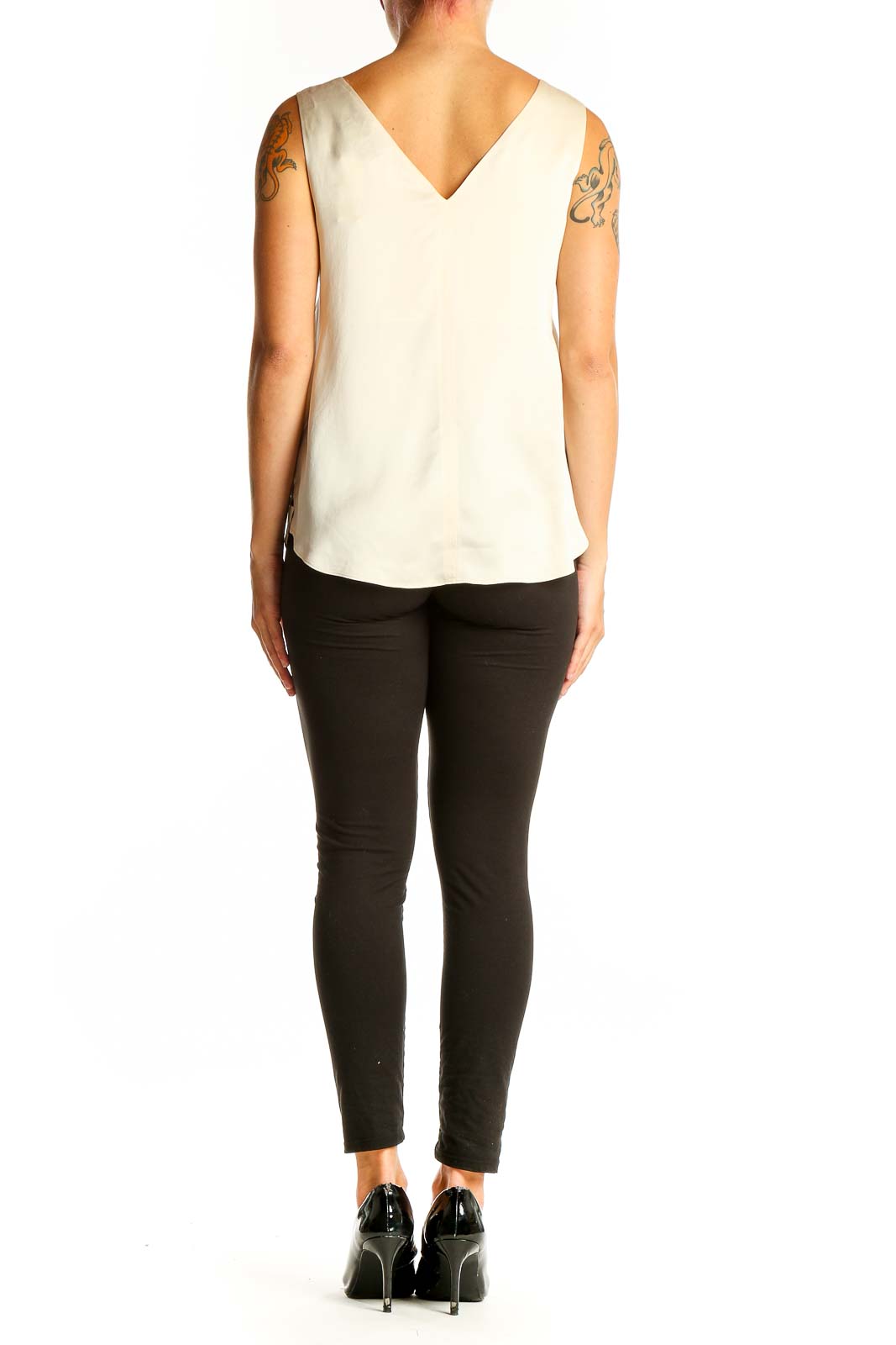Side view of model wearing Autograph ivory silk sleeveless top with black pants