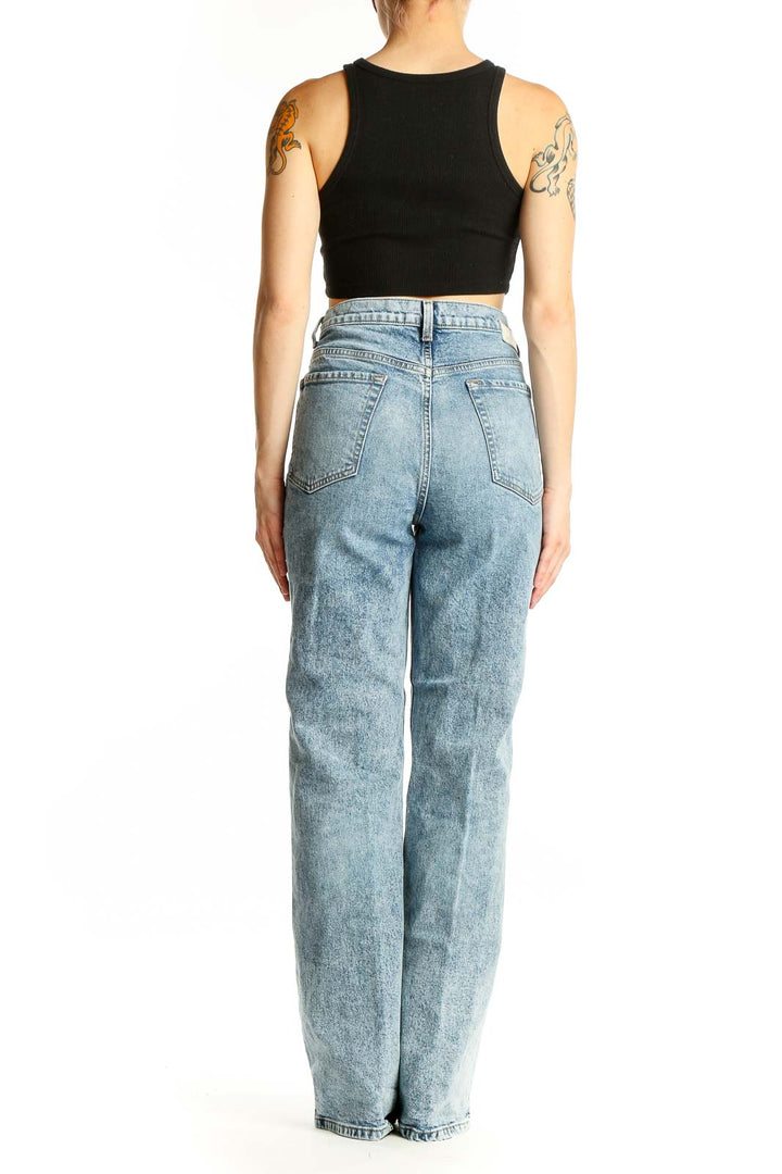Side view of model wearing C/E Current/Elliott light blue acid wash high-waisted wide-leg jeans