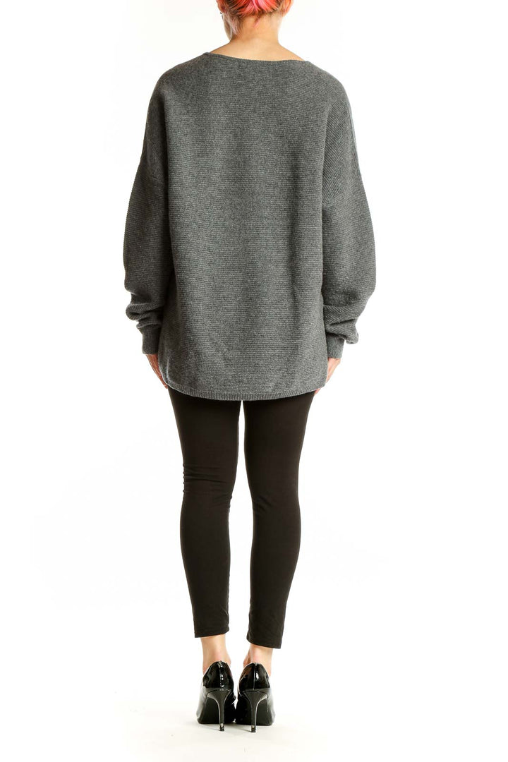 Side view of model wearing gray Nordstrom Signature cashmere V-neck oversized sweater with black pants