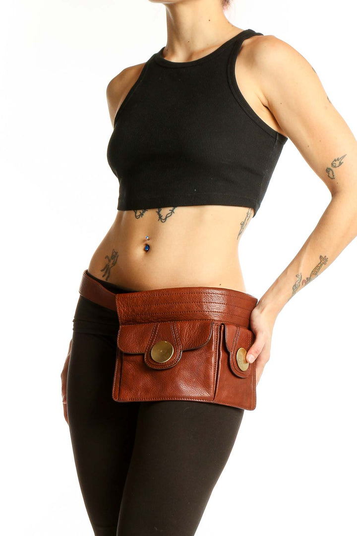 Front view of brown leather Shih belt bag with gold button accents