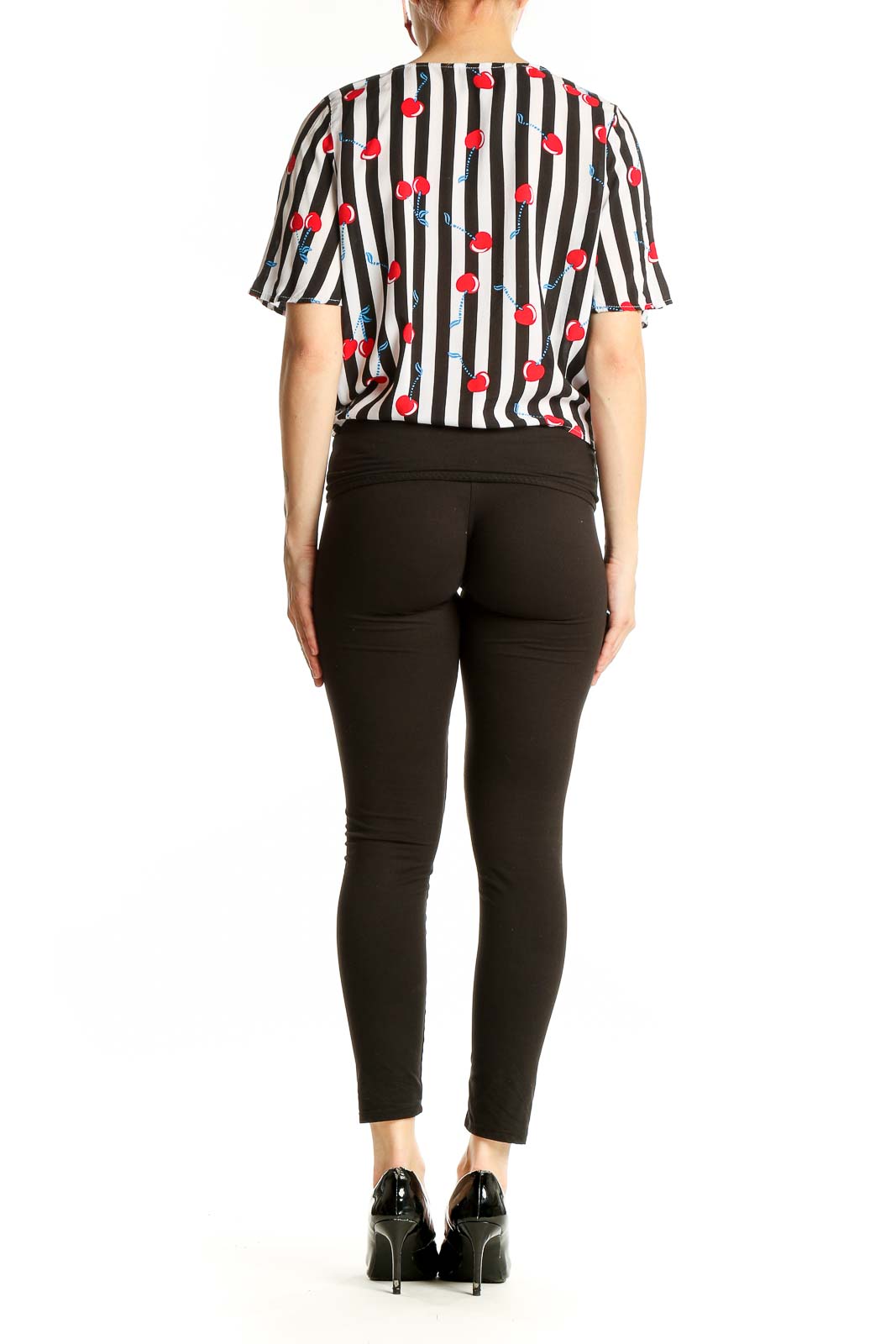 Side view of model wearing Cynthia Rowley black and white striped top with cherry print