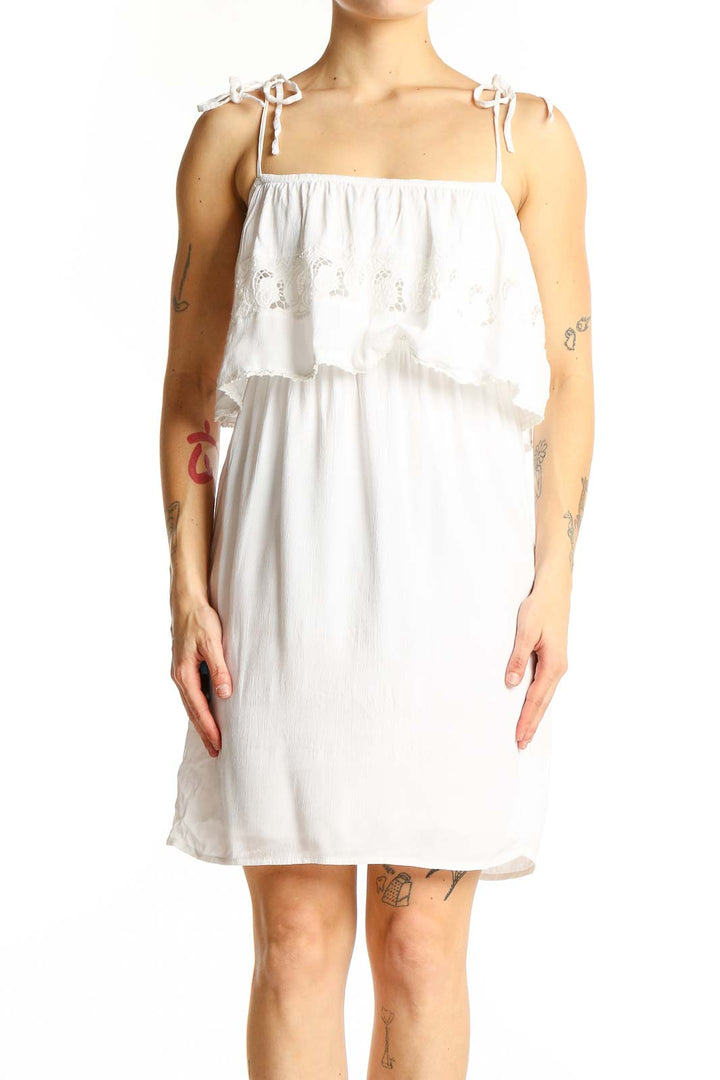 Front view of white cotton tiered ruffle sundress by L space