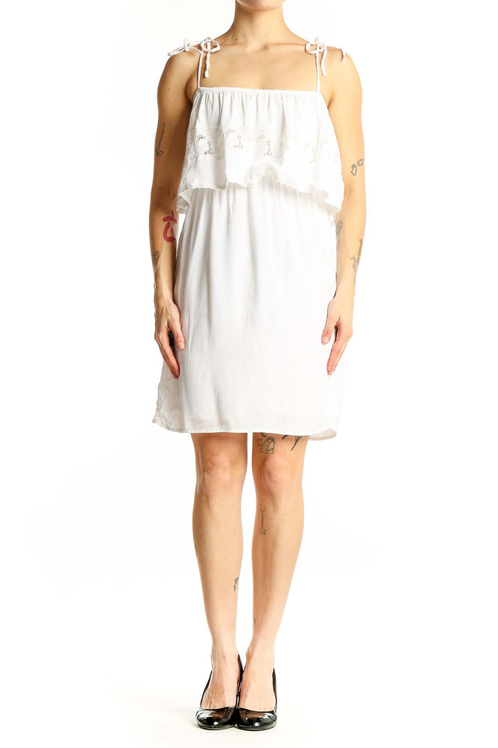 Front view of white cotton tiered ruffle sundress by L space