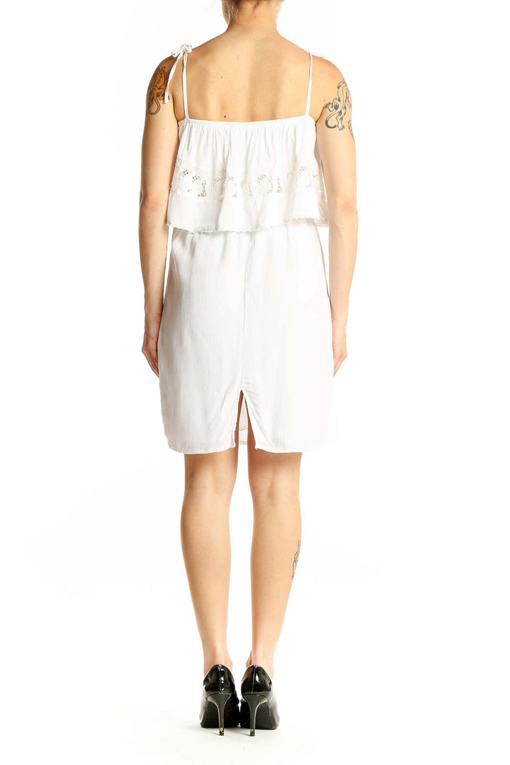 Side view of white cotton tiered ruffle sundress by L space