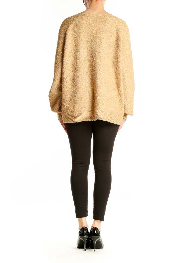 Side view of model wearing beige LOFT V-neck oversized knit sweater