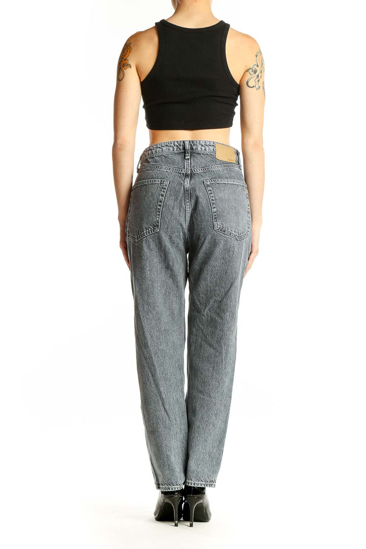 Side view of woman wearing Rag & Bone gray vintage-wash high-waisted straight leg jeans