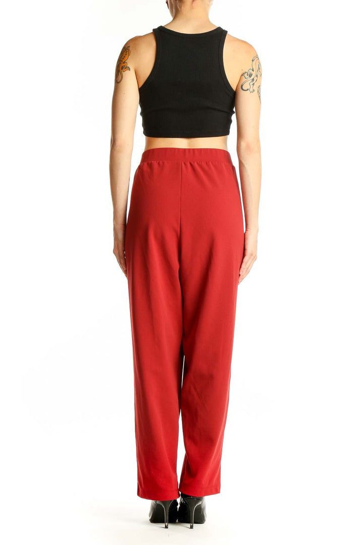 Side view of woman wearing red wide-leg pants from LOFT with black top