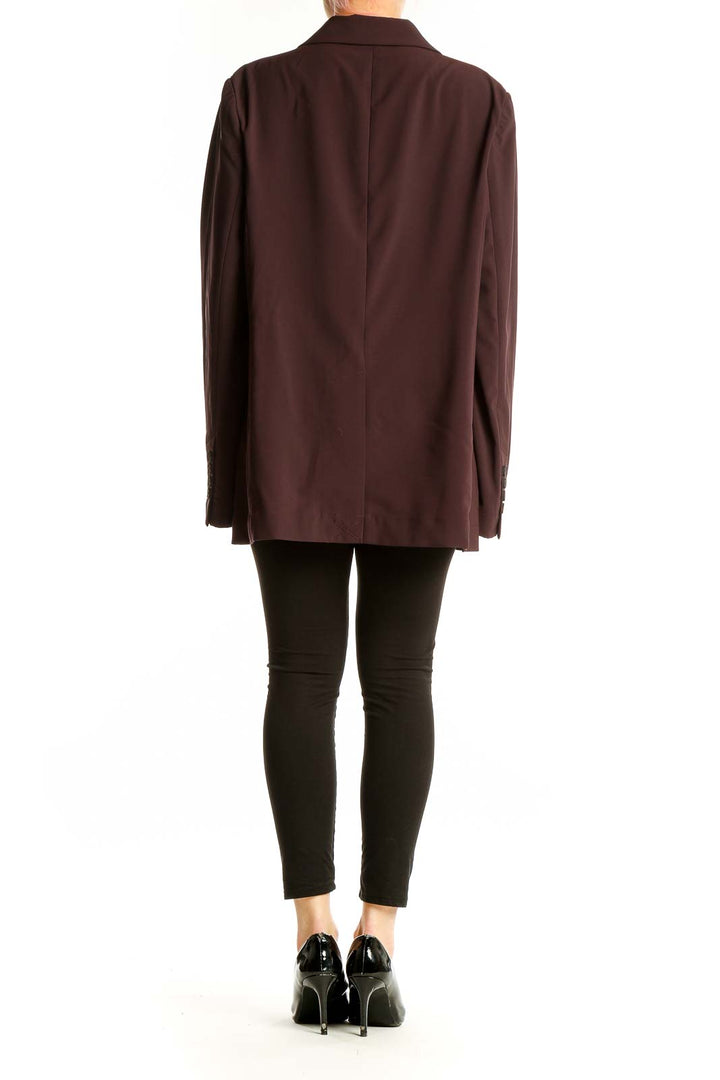 Side view of model wearing burgundy double-breasted oversized blazer by MM. LaFleur