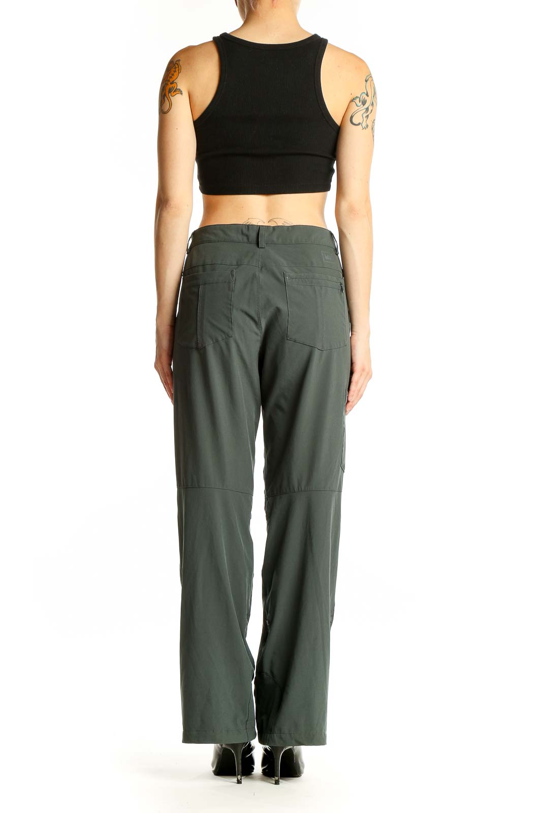 Side view of woman wearing olive green REI hiking pants
