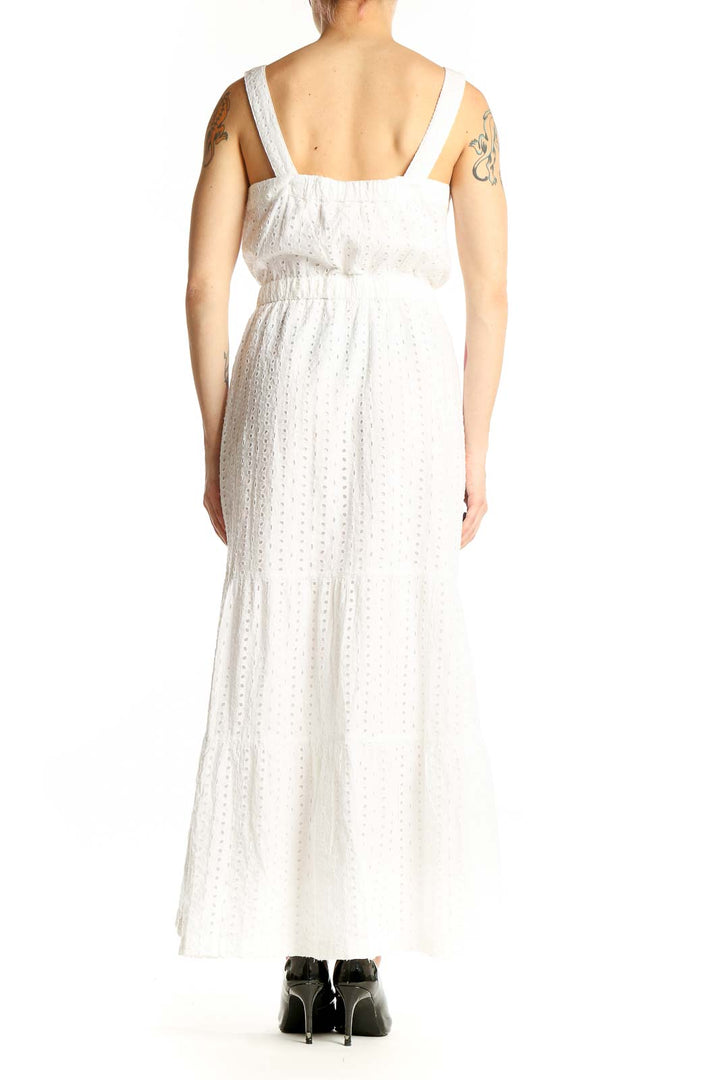 Side view of Gap white cotton eyelet maxi dress showing flowing tiered skirt