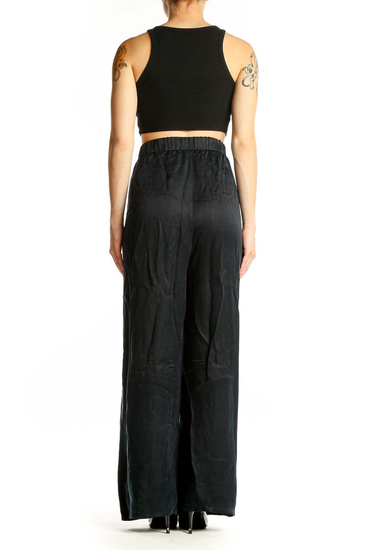 Side view of model wearing Eileen Fisher black Cupro wide-leg palazzo pants