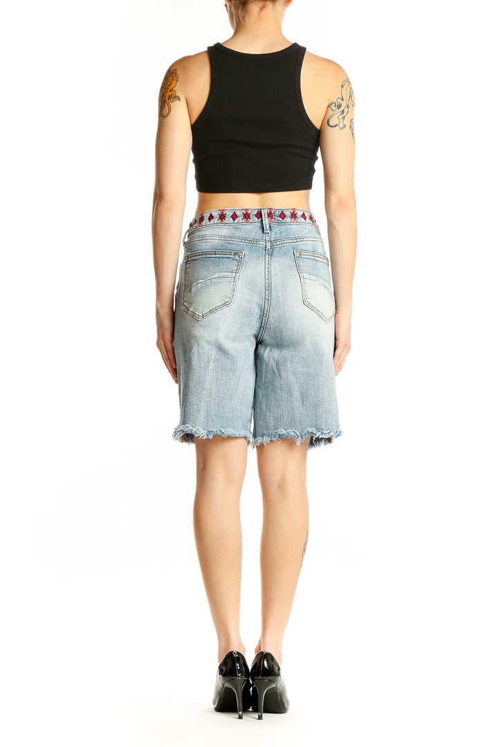 Side view of Driftwood denim Bermuda shorts showing embroidered side seam detail