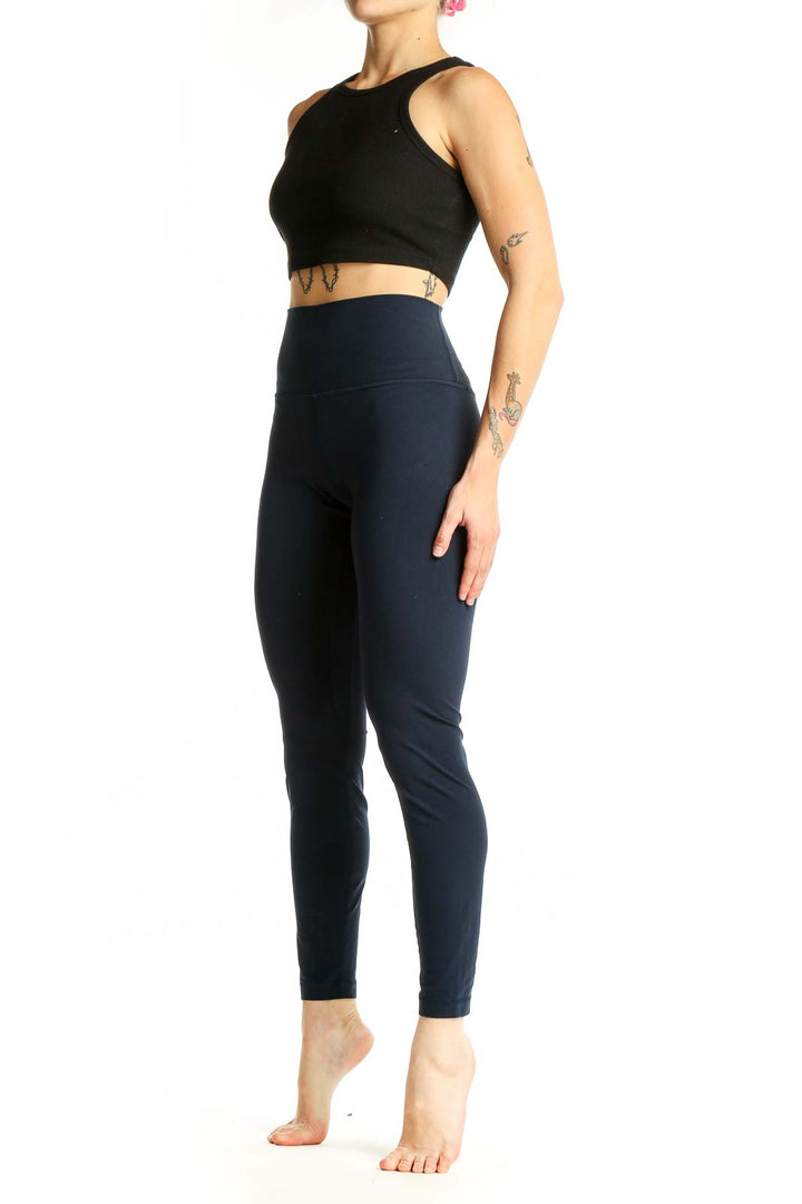 Front view of Lululemon navy high-waisted leggings on model