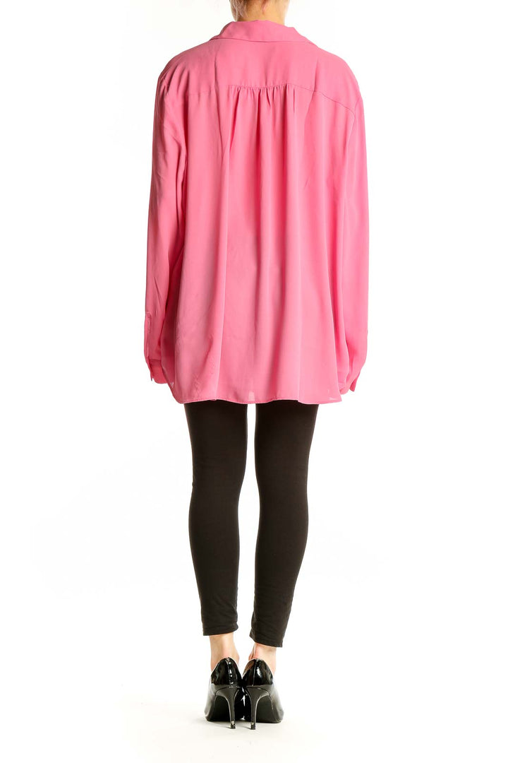 Side view of Ann Taylor pink polyester blouse showing relaxed fit