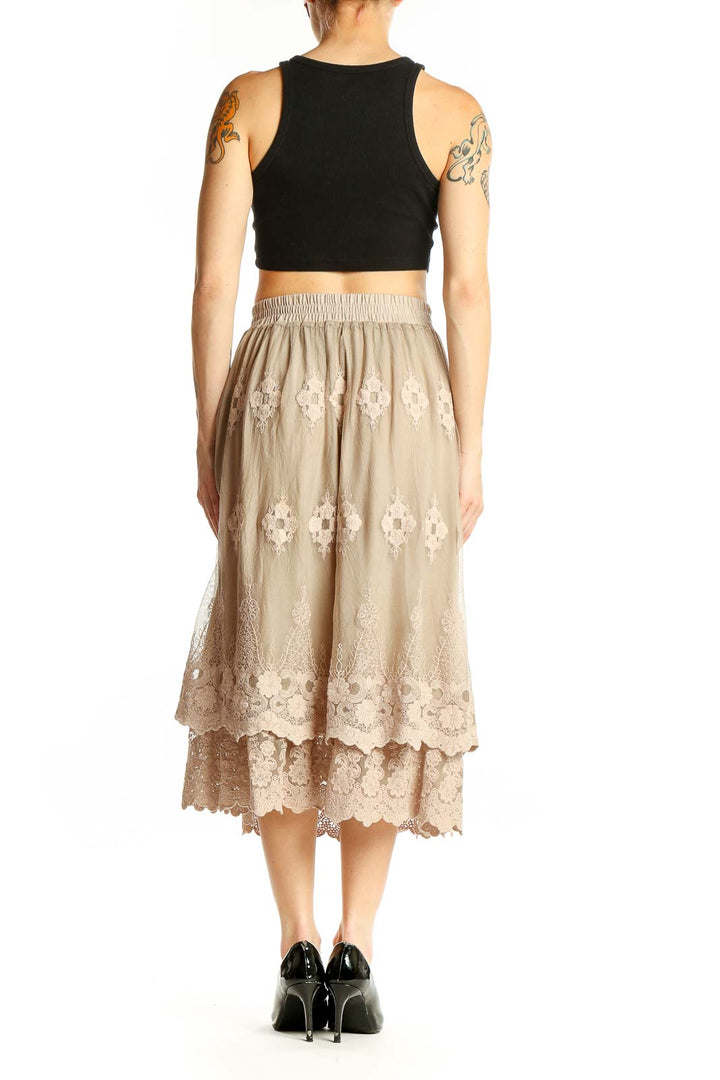 Side view of model wearing Indigo Soul beige lace embroidered midi skirt