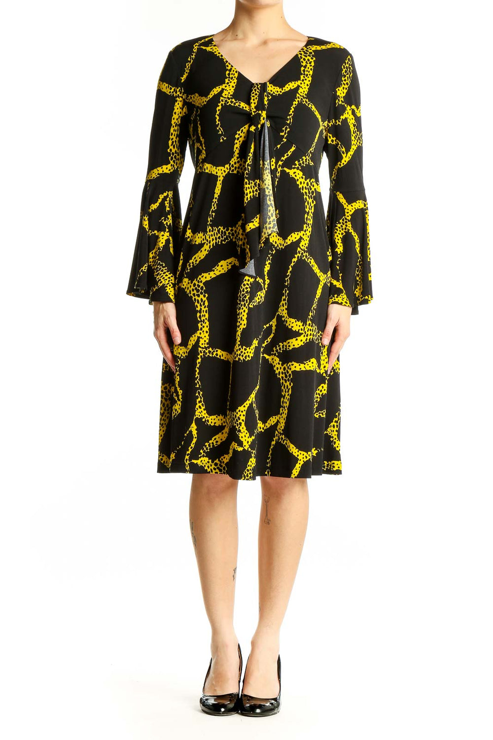 Front view of Vicky Tiel Black and Yellow Giraffe Print Dress with V-neckline and bell sleeves
