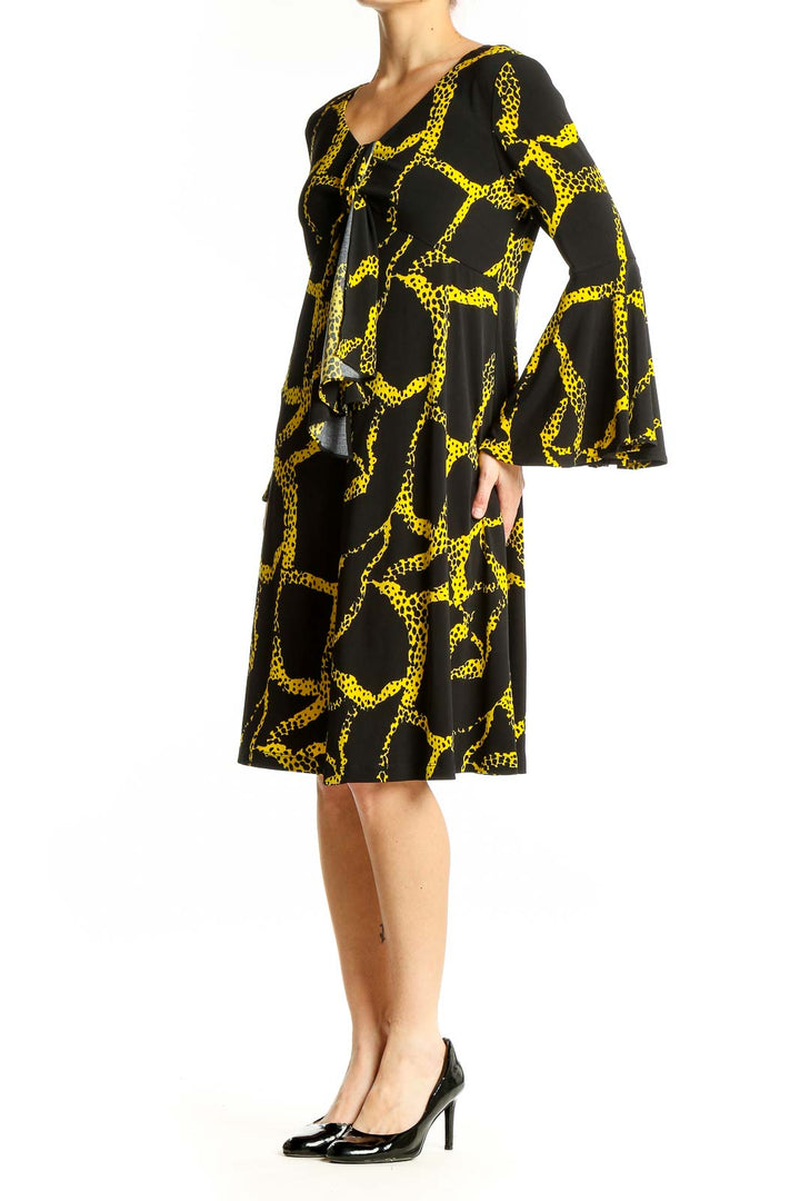 Front view of Vicky Tiel Black and Yellow Giraffe Print Dress with V-neckline and bell sleeves