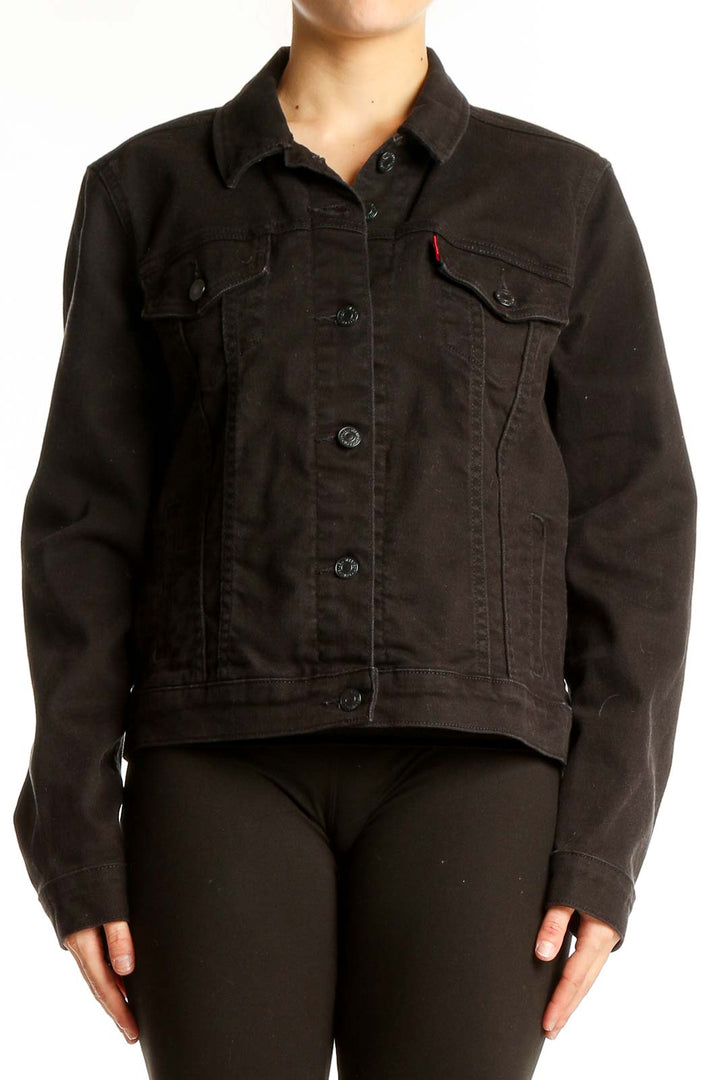 Front view of black Levi's denim jacket with button-up closure and chest pockets