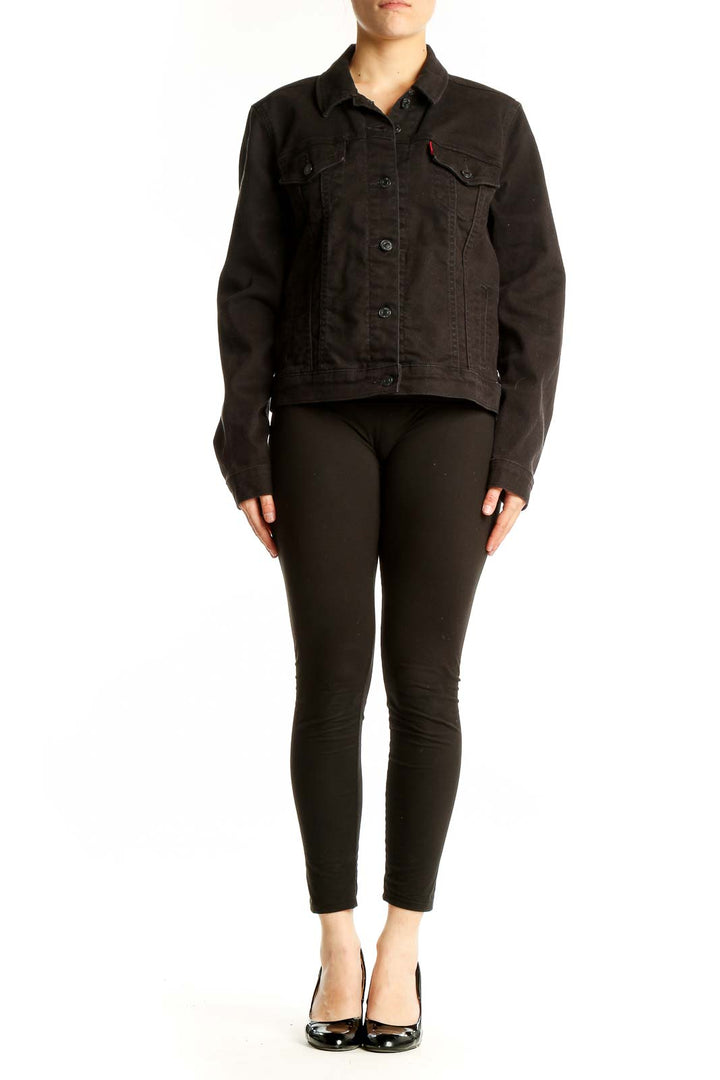 Front view of black Levi's denim jacket with button-up closure and chest pockets