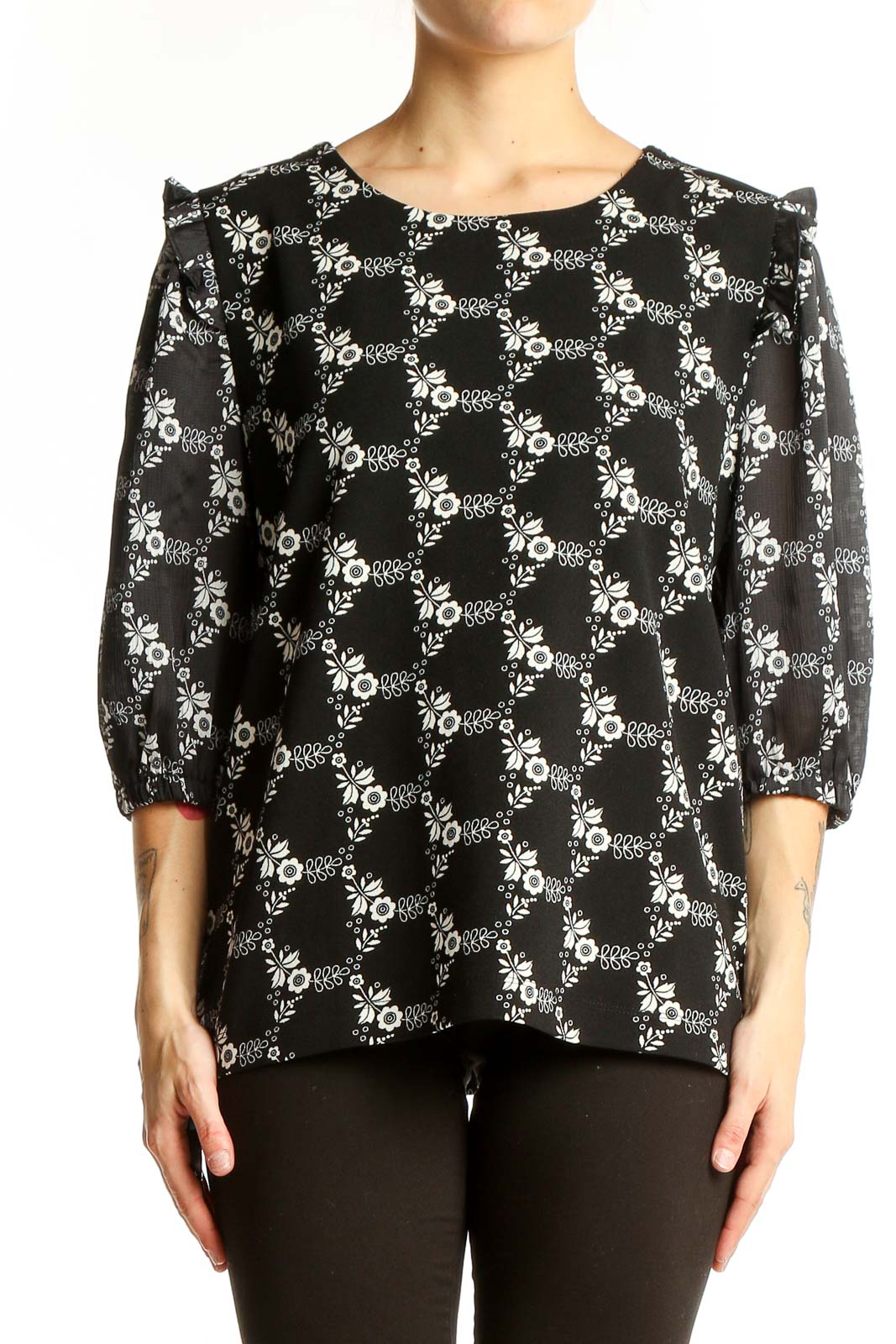 Front view of Ann Taylor black blouse with white floral print and puff sleeves