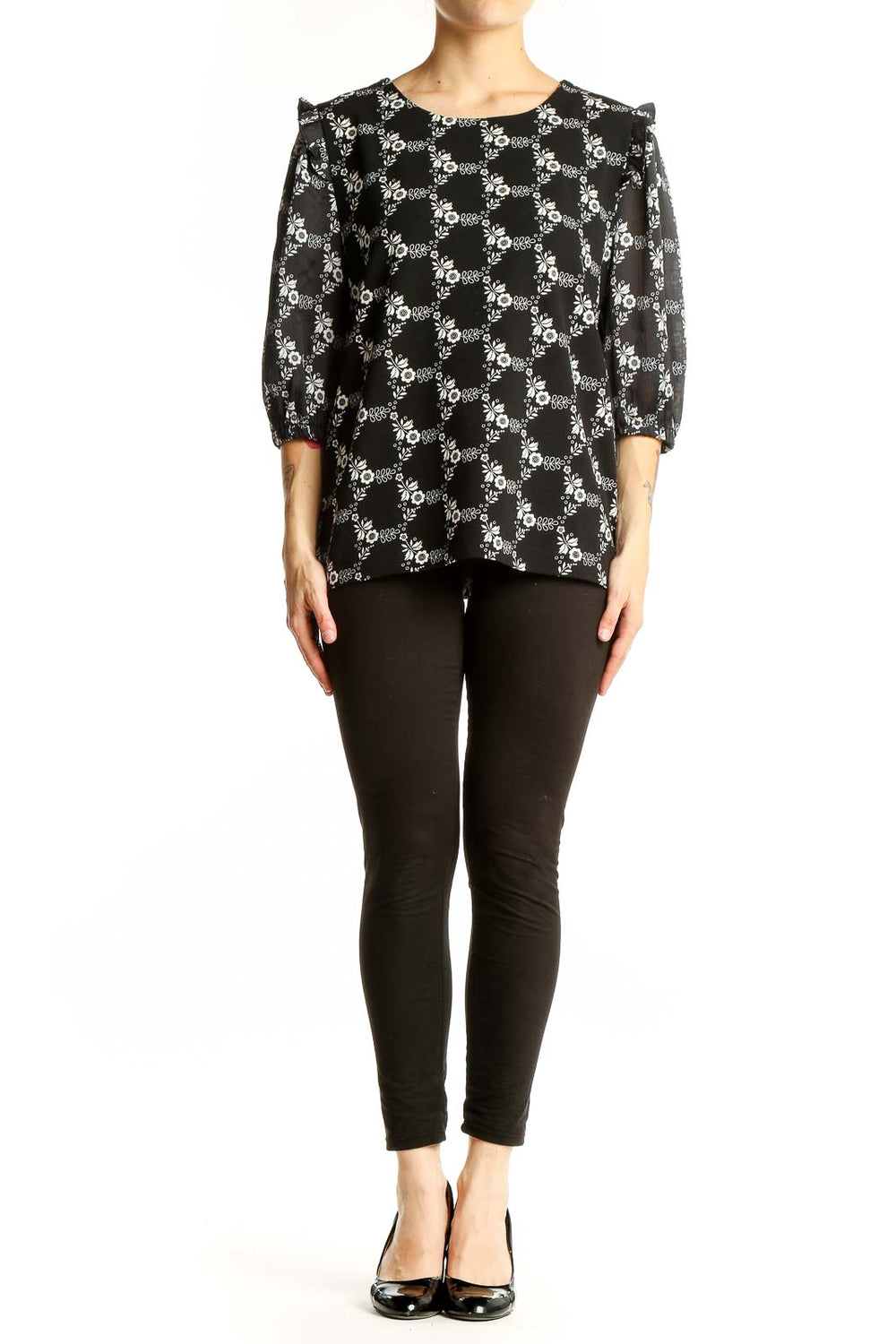 Front view of Ann Taylor black blouse with white floral print and puff sleeves