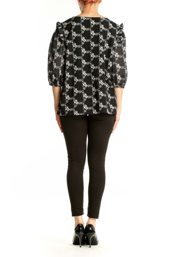 Side view of Ann Taylor black floral print blouse showing puff sleeve detail