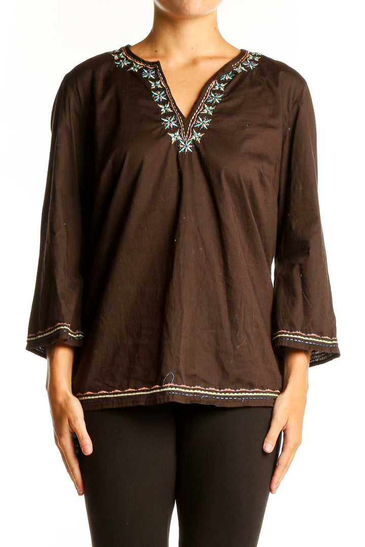 Front view of brown Talbots tunic top with floral embroidery and bell sleeves