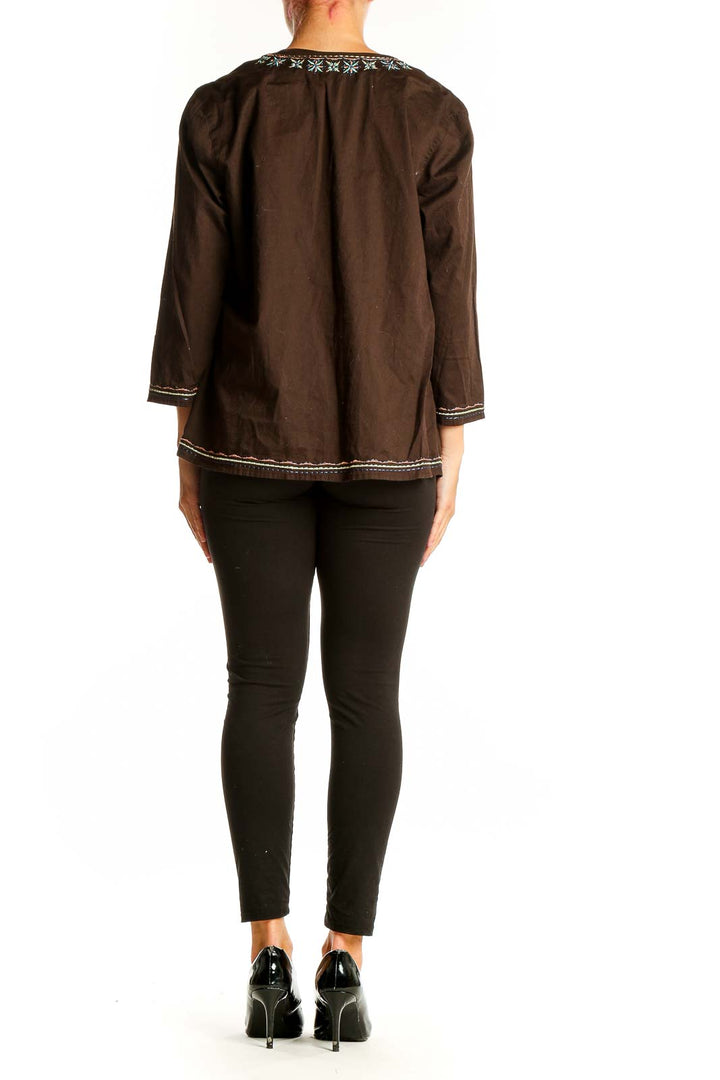 Back view of brown Talbots tunic top showing relaxed fit and embroidered hem