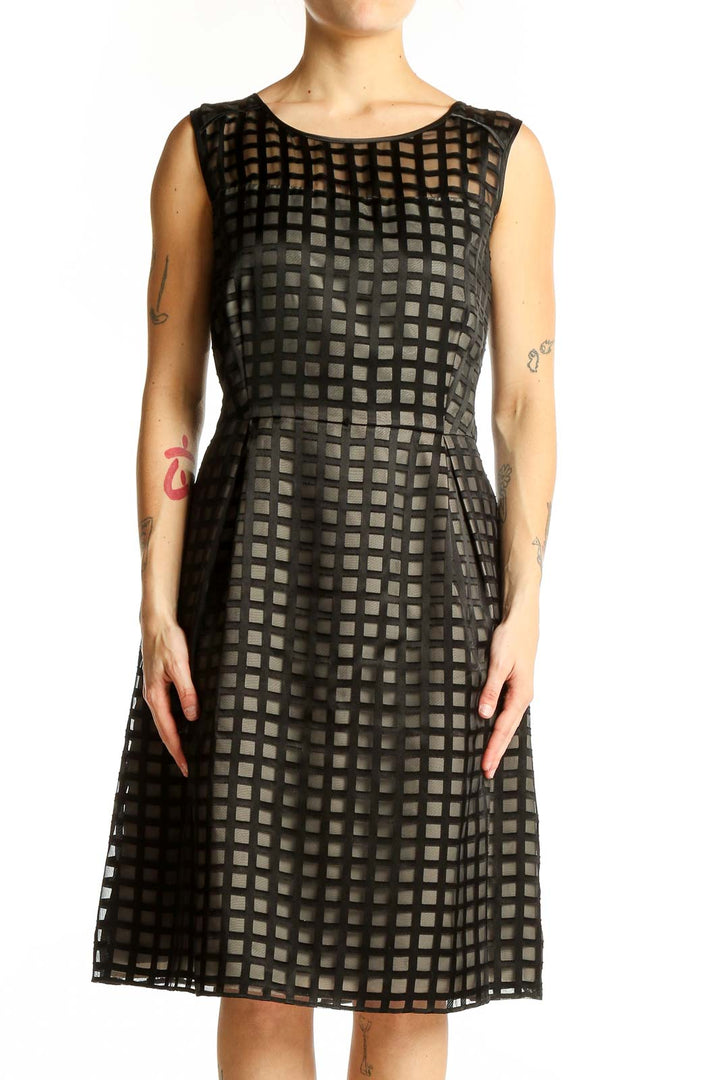 Front view of black Calvin Klein cocktail dress with grid pattern overlay