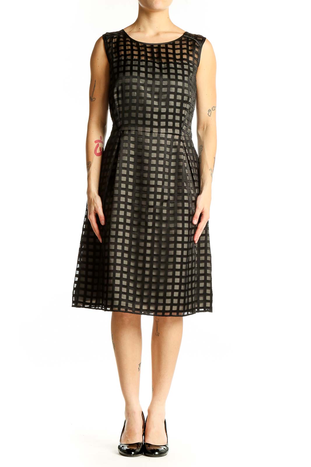 Front view of black Calvin Klein cocktail dress with grid pattern overlay