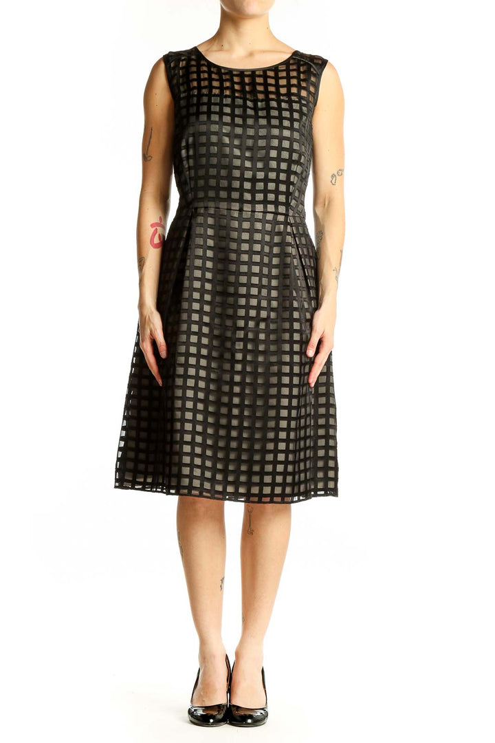 Front view of black Calvin Klein cocktail dress with grid pattern overlay