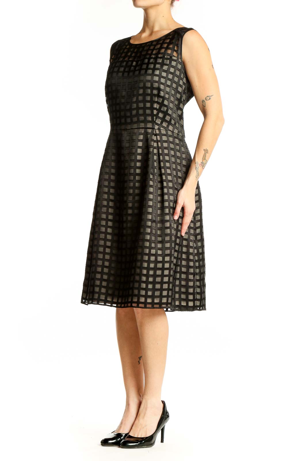 Front view of black Calvin Klein cocktail dress with grid pattern overlay